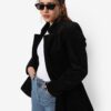 women wearing a black blazer with white t-shirt and blue jeans