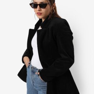 women wearing a black blazer with white t-shirt and blue jeans