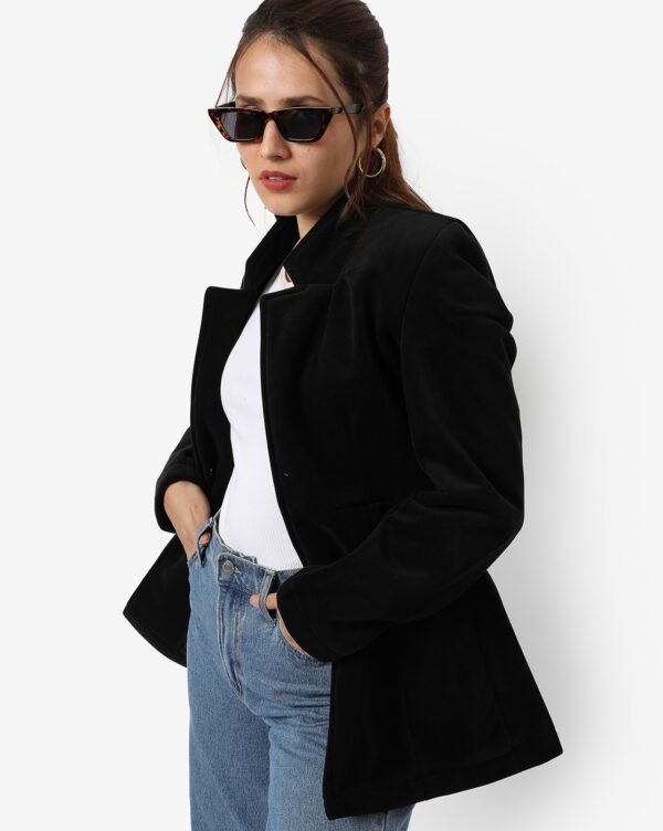 women wearing a black blazer with white t-shirt and blue jeans